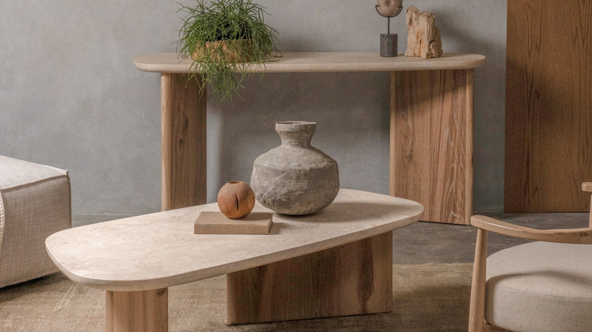 Travertine top coffee table with solid oak base styled with console table and modern timber furniture in a warm contemporary living room.