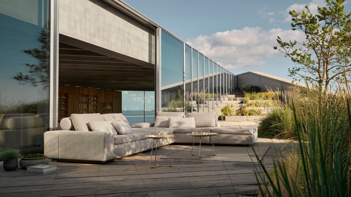 Architectural terrace with HOUE DRIFT modular outdoor lounge sofa and side tables, Danish outdoor furniture for modern patios and coastal living.