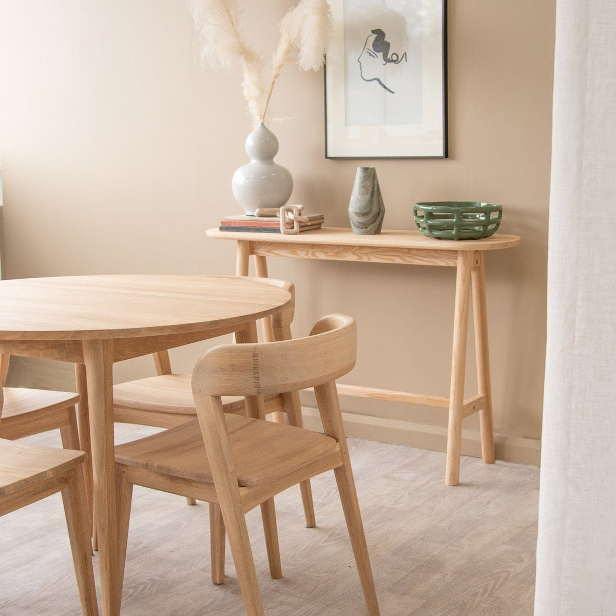Wooden table and chairs in a beige room.