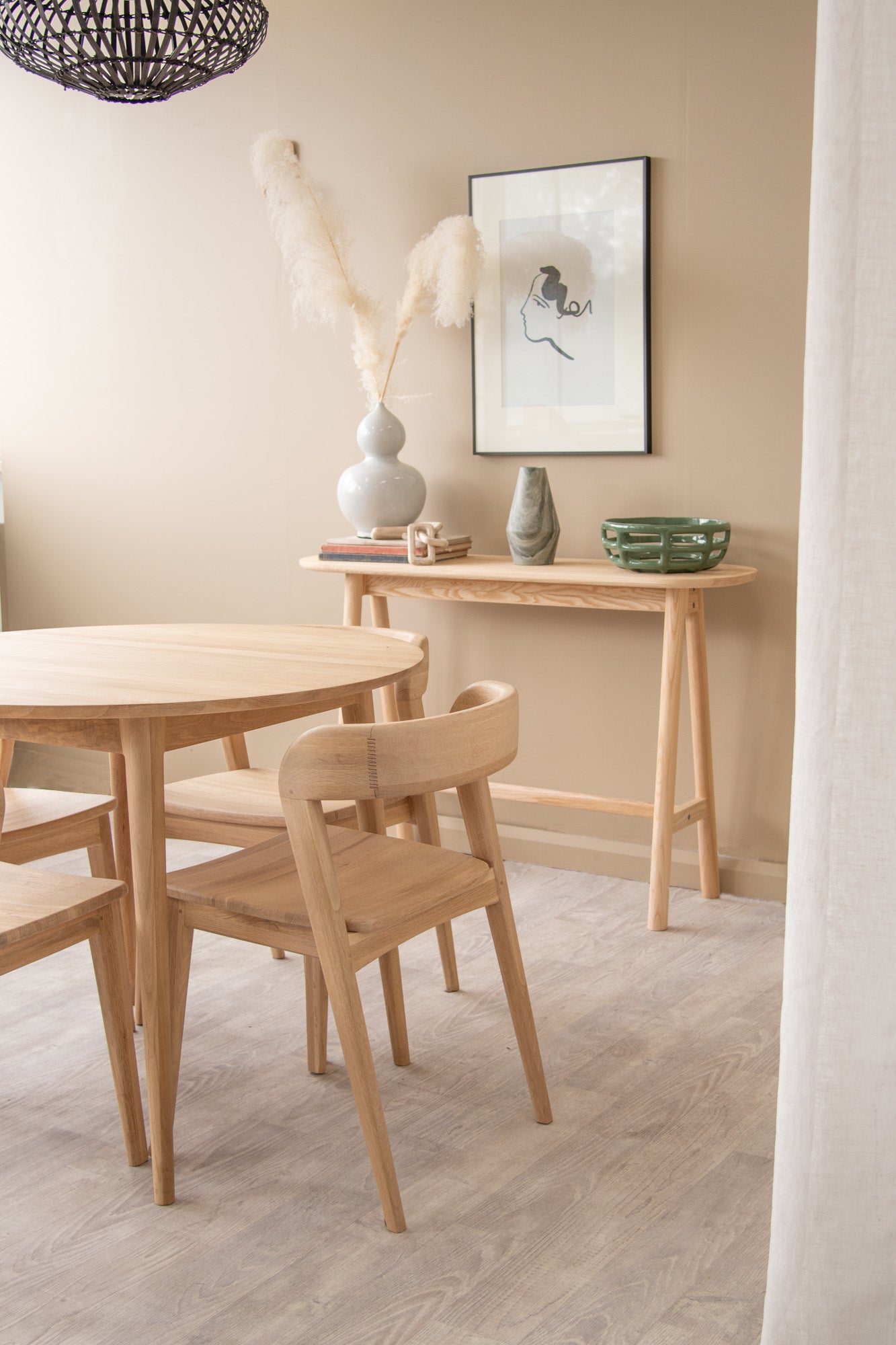 Wooden table and chairs in a beige room.