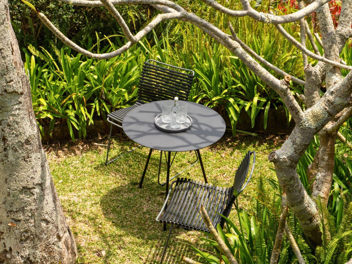 Outdoor table and chairs in a garden.