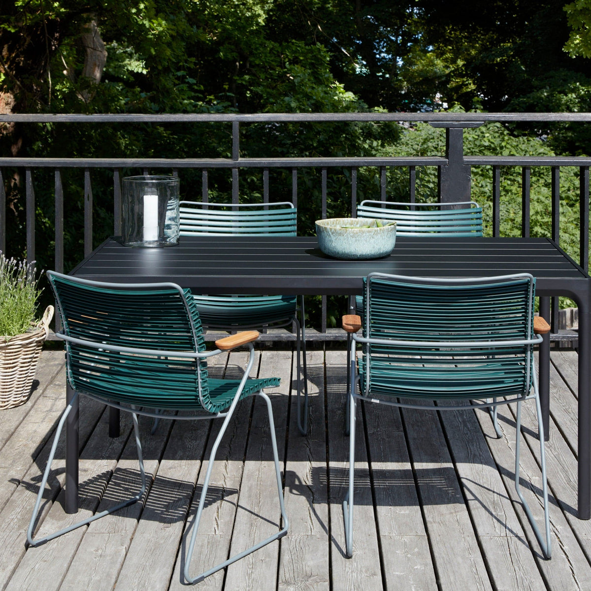 Outdoor table and chairs on a wooden deck.