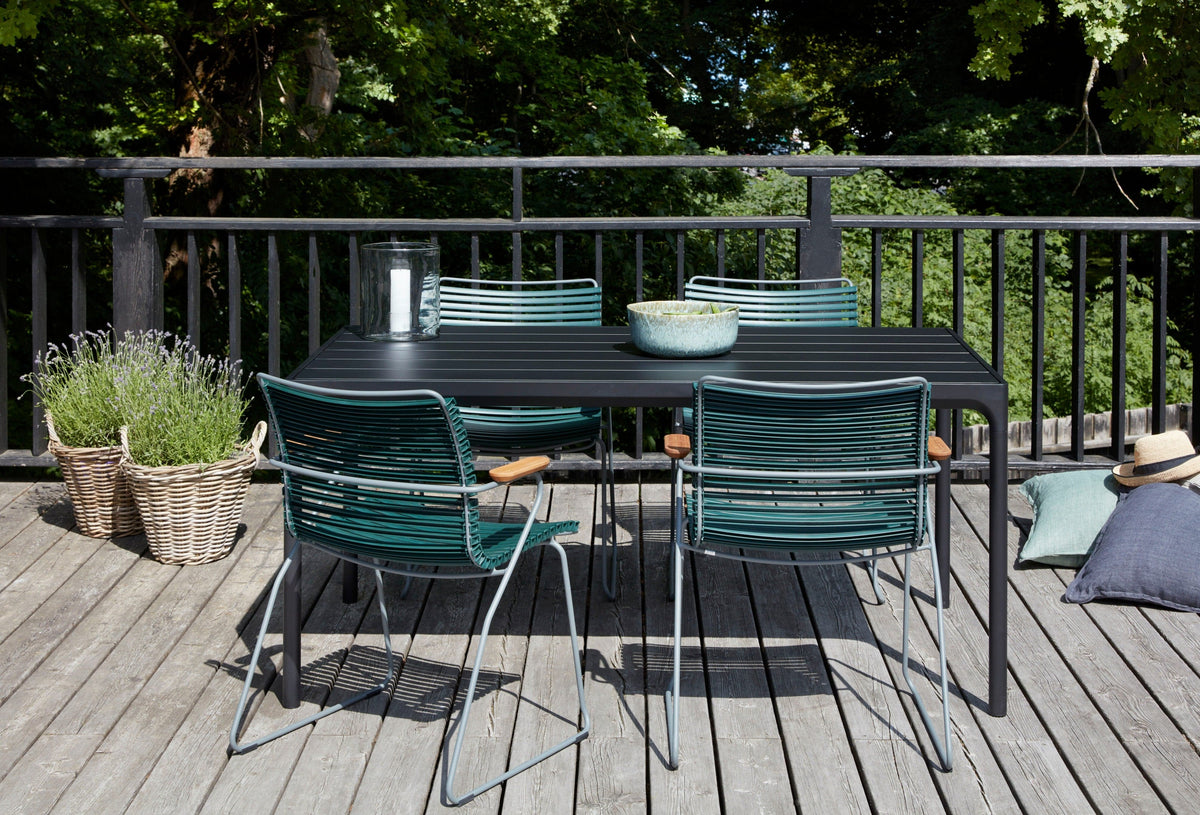Outdoor table and chairs on a wooden deck.