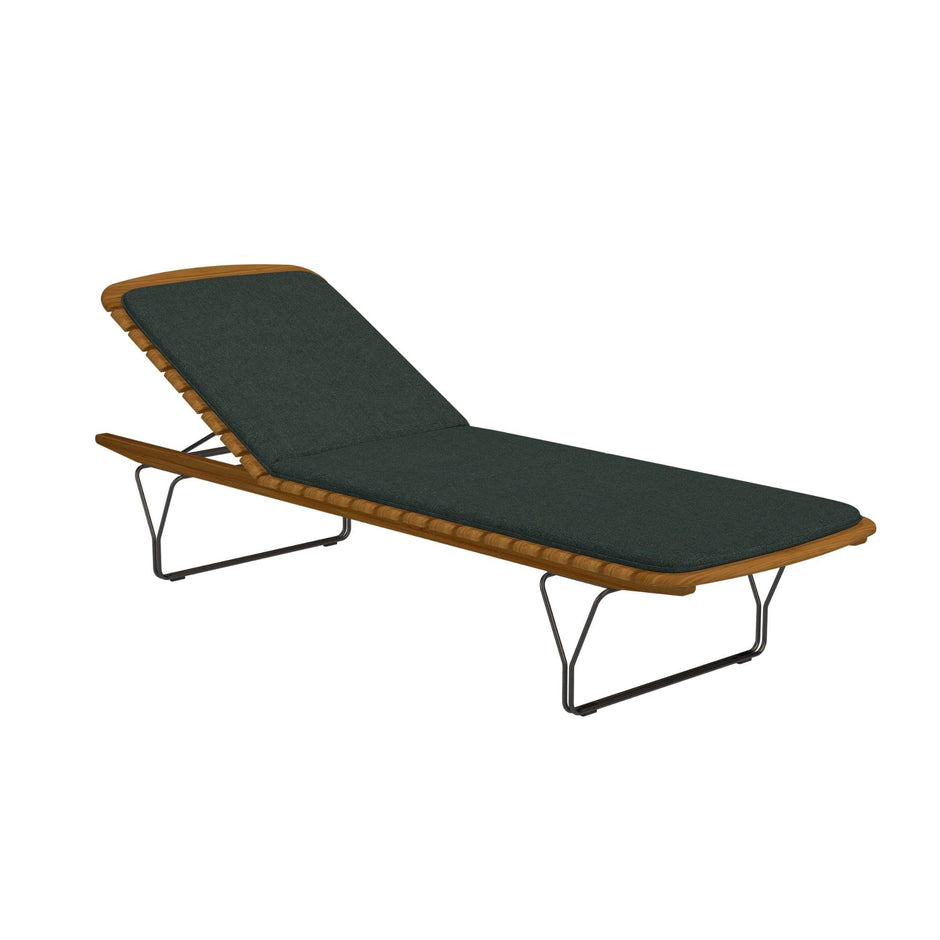 Outdoor chaise lounge with green cushion.