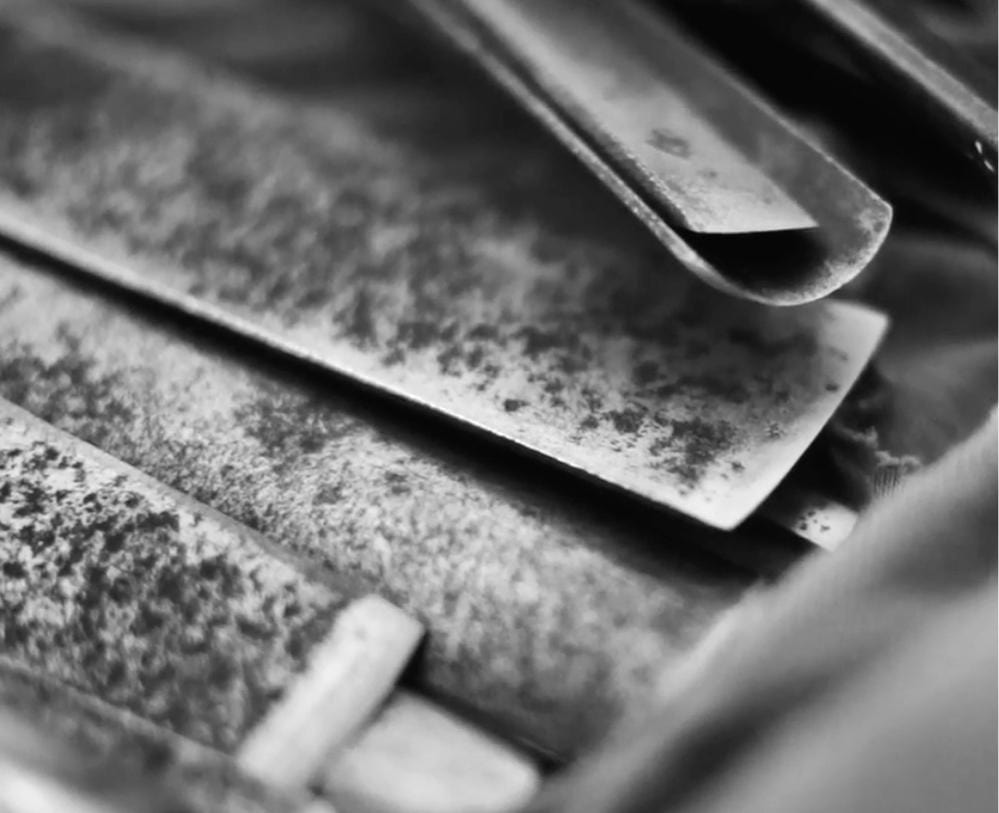 Close-up of vintage metal blades, possibly tools, with rust