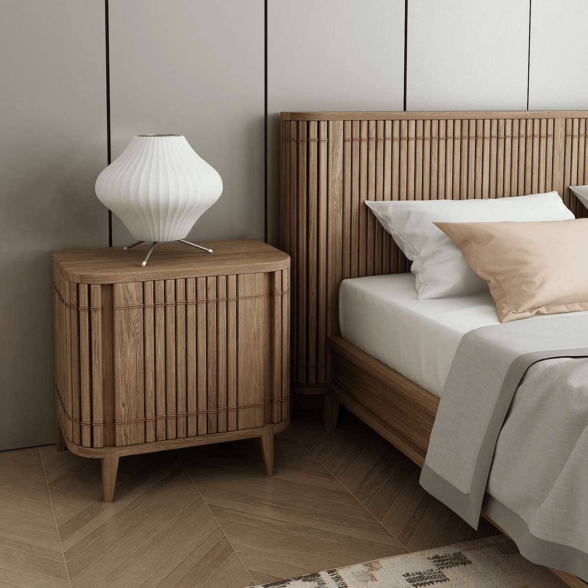 Wooden nightstand with lamp next to a bed.