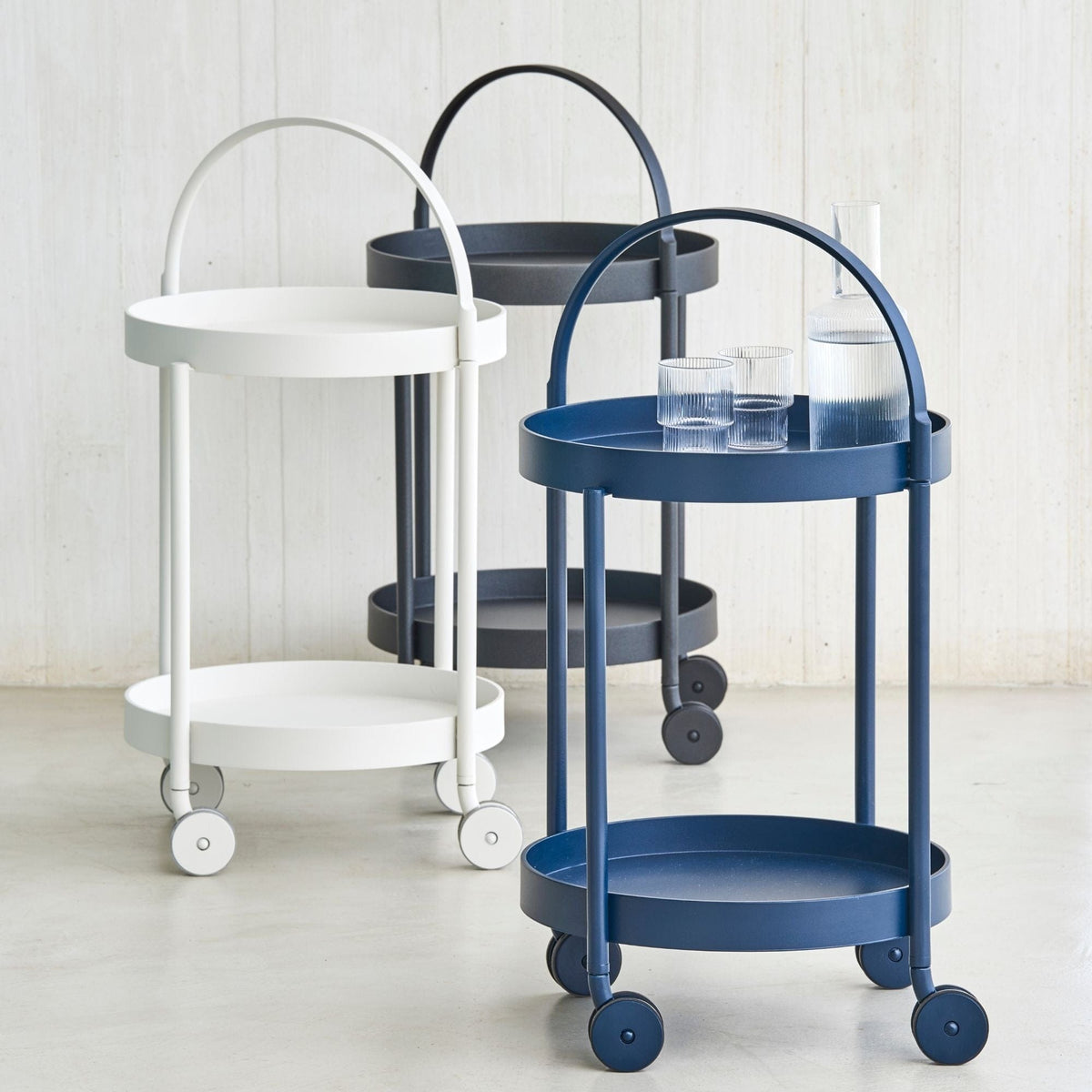Round rolling serving carts in white, gray, and blue