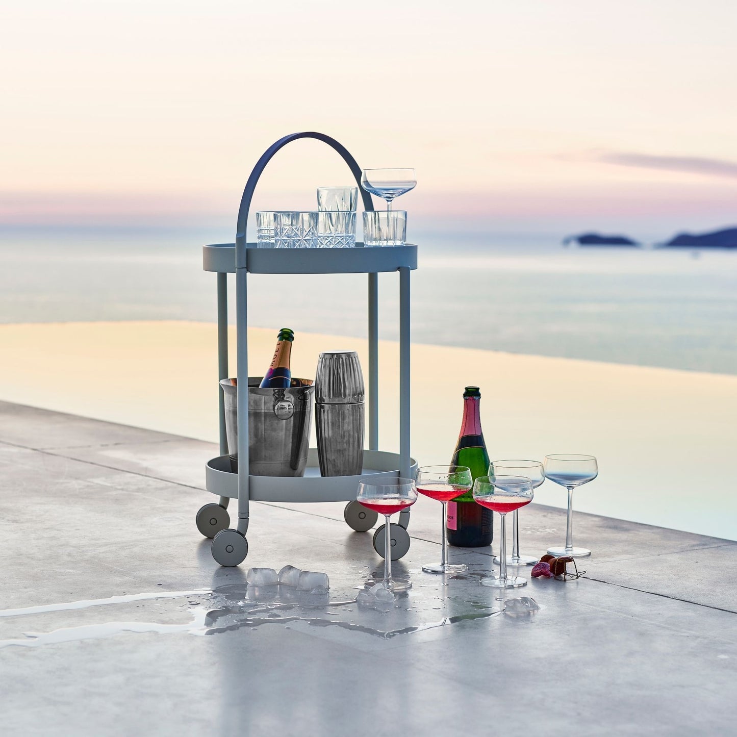 Outdoor bar cart with drinks and glasses