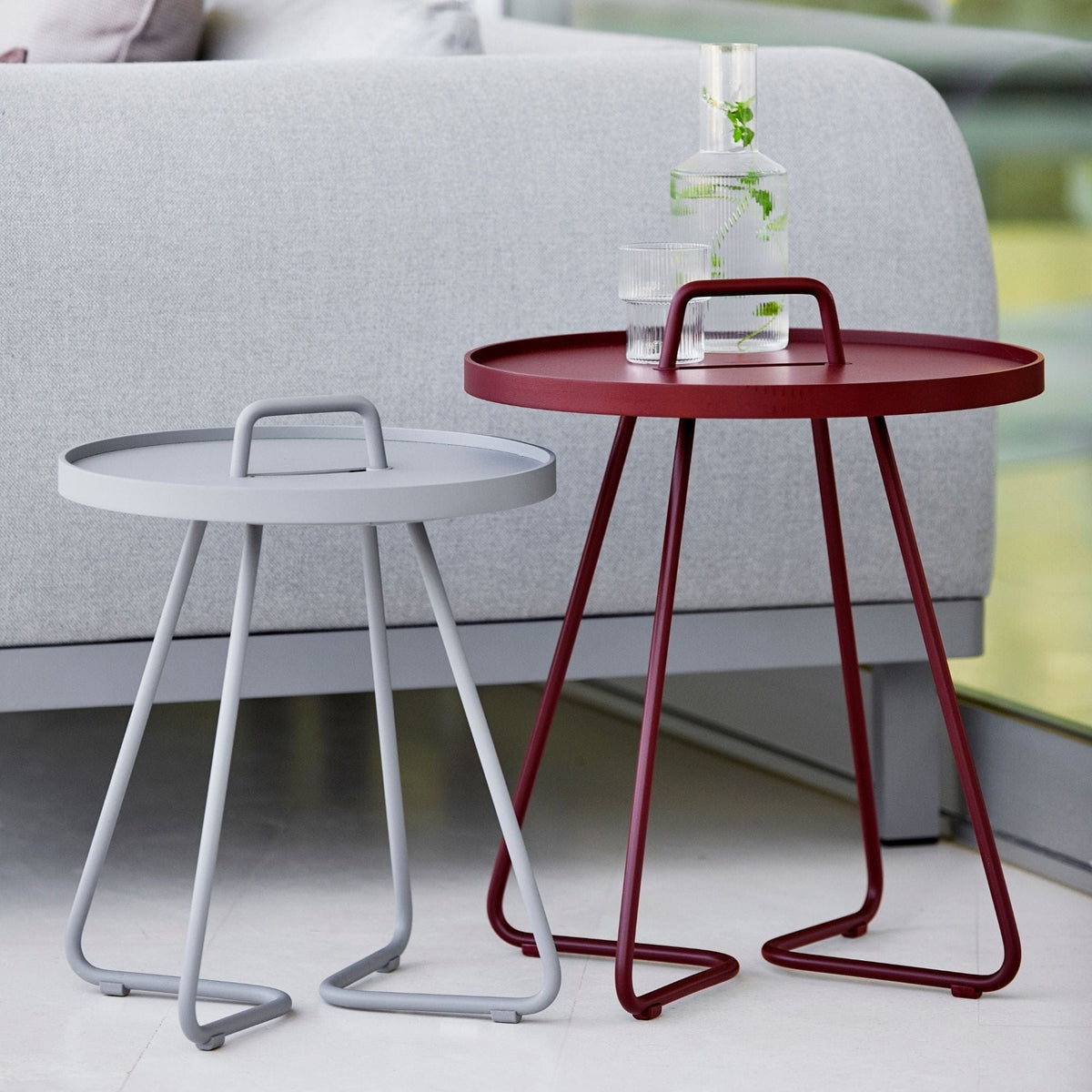 Modern side tables, red and grey with handles.