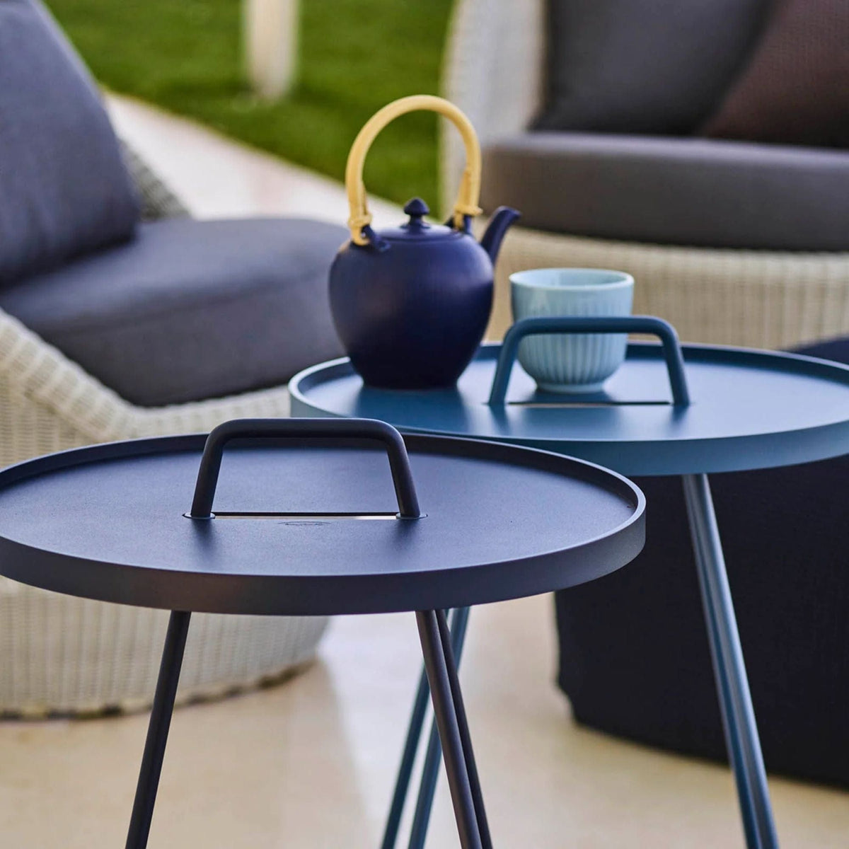 Blue side tables with tea set.