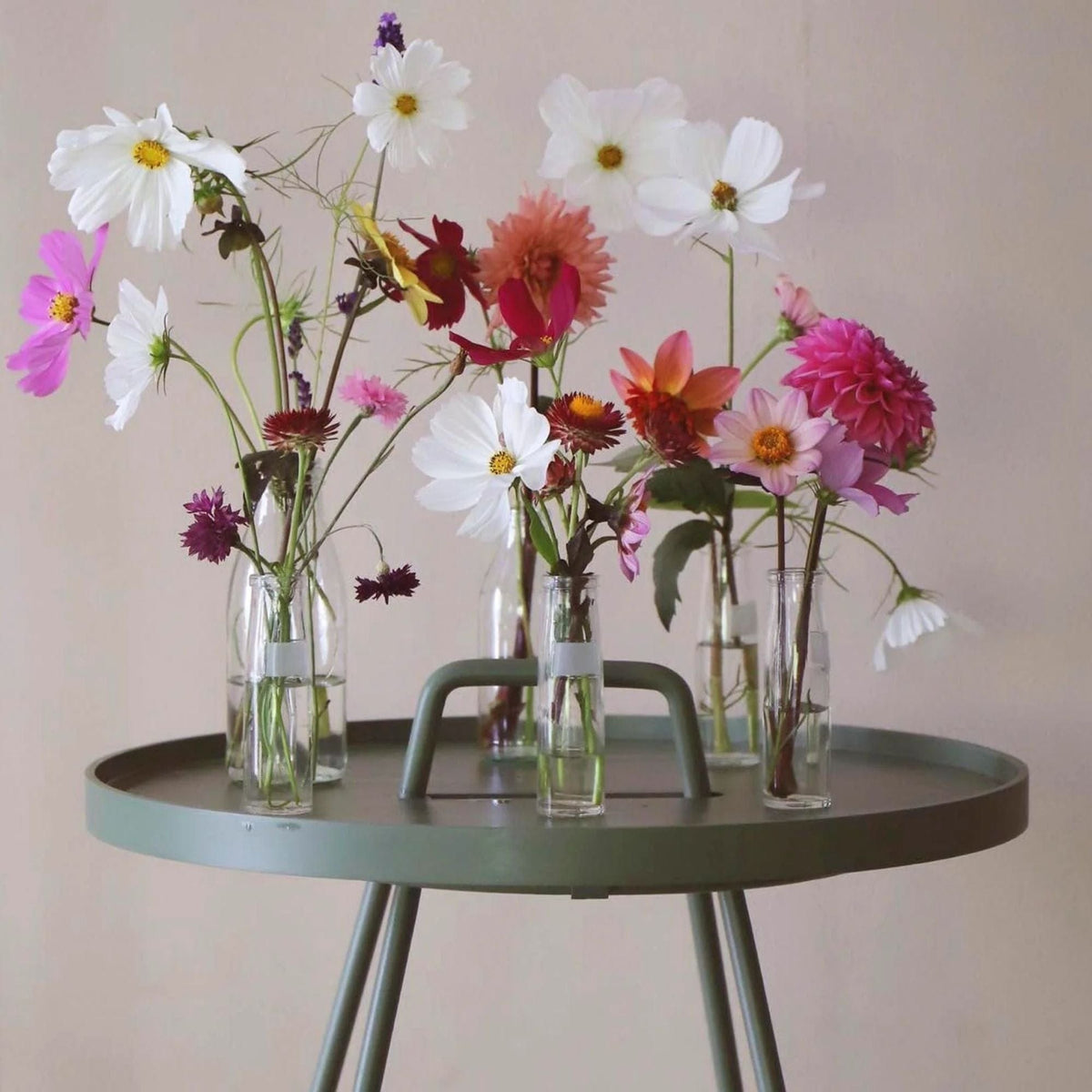 Arrangement of colorful flowers in vases on a green table - 5065ADG_2