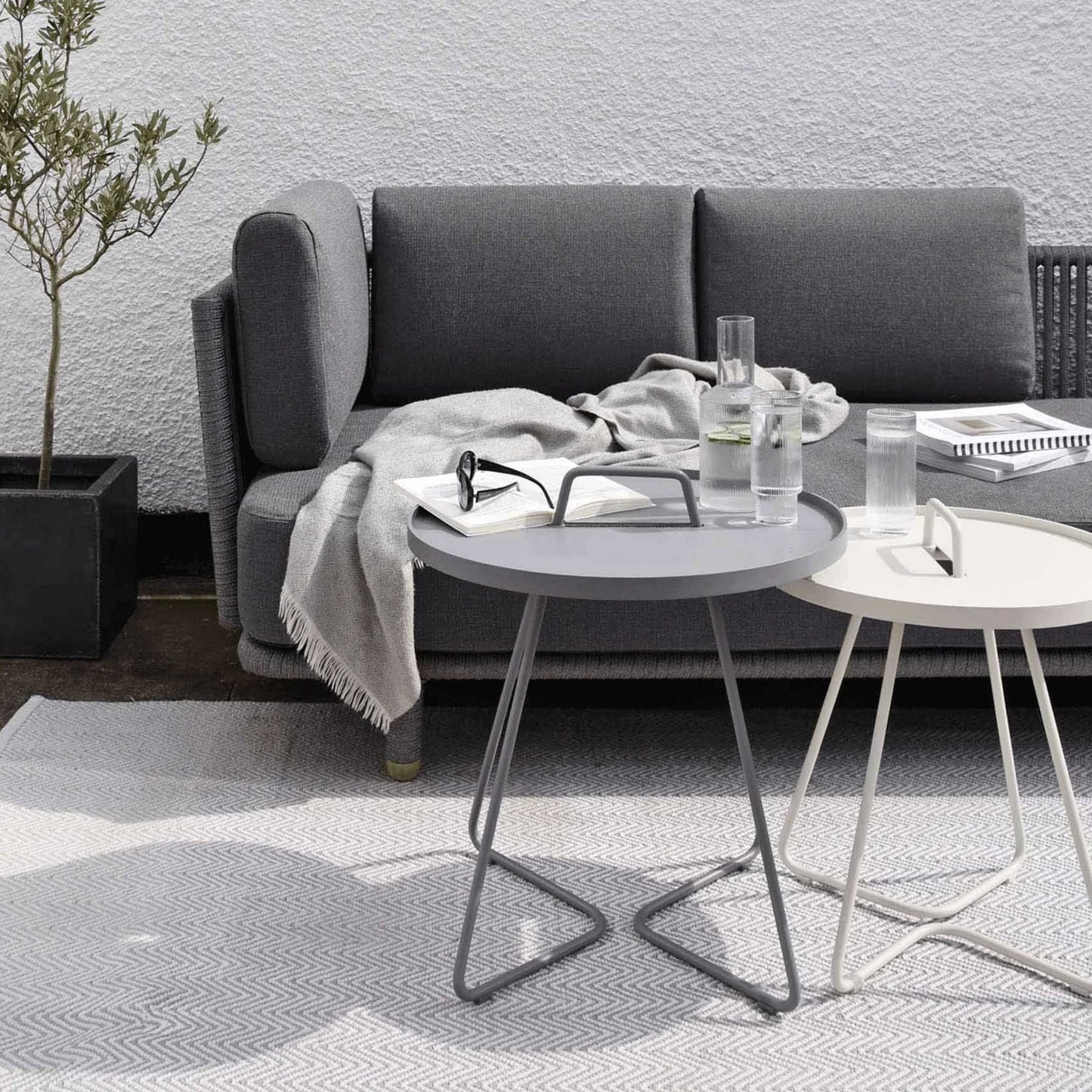 Modern patio furniture with grey sofa and side tables