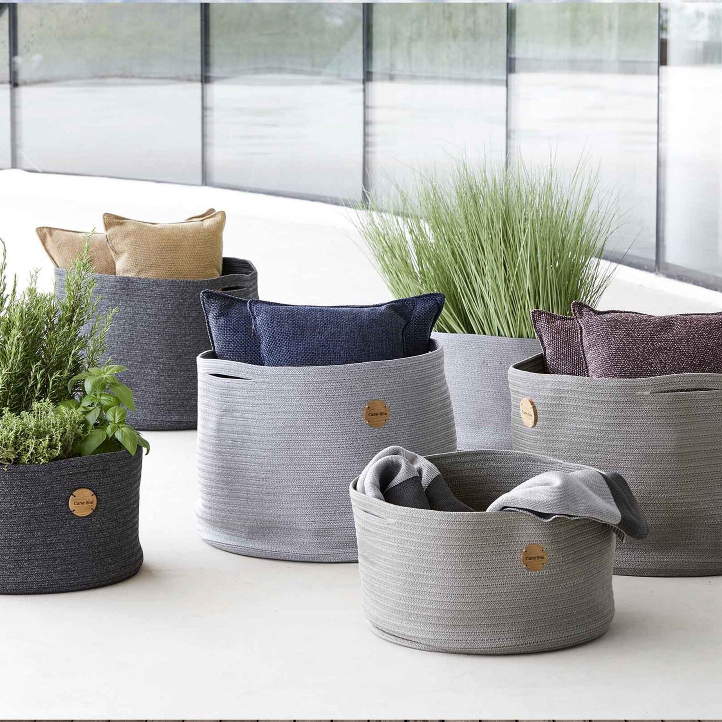 Outdoor rope baskets with pillows and plants