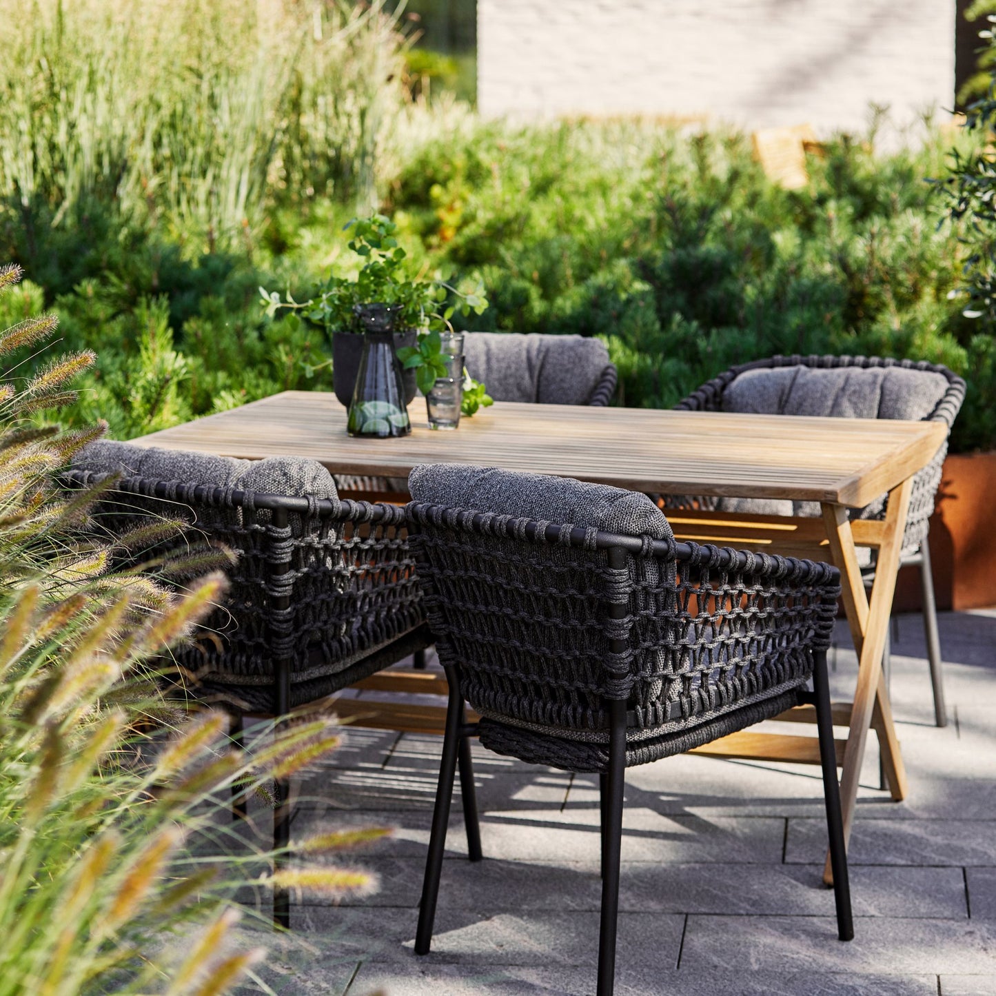 Outdoor dining set 5417RODG_2 with woven chairs and table.