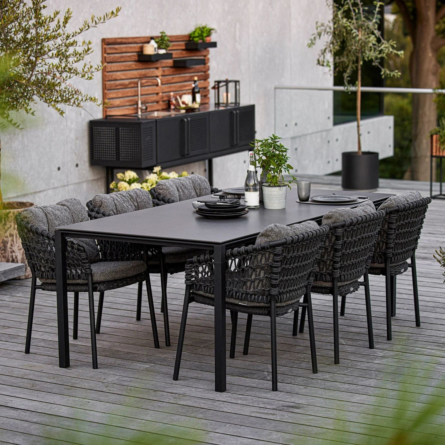 Outdoor dining set 5417RODG_4_2 with black table and chairs.