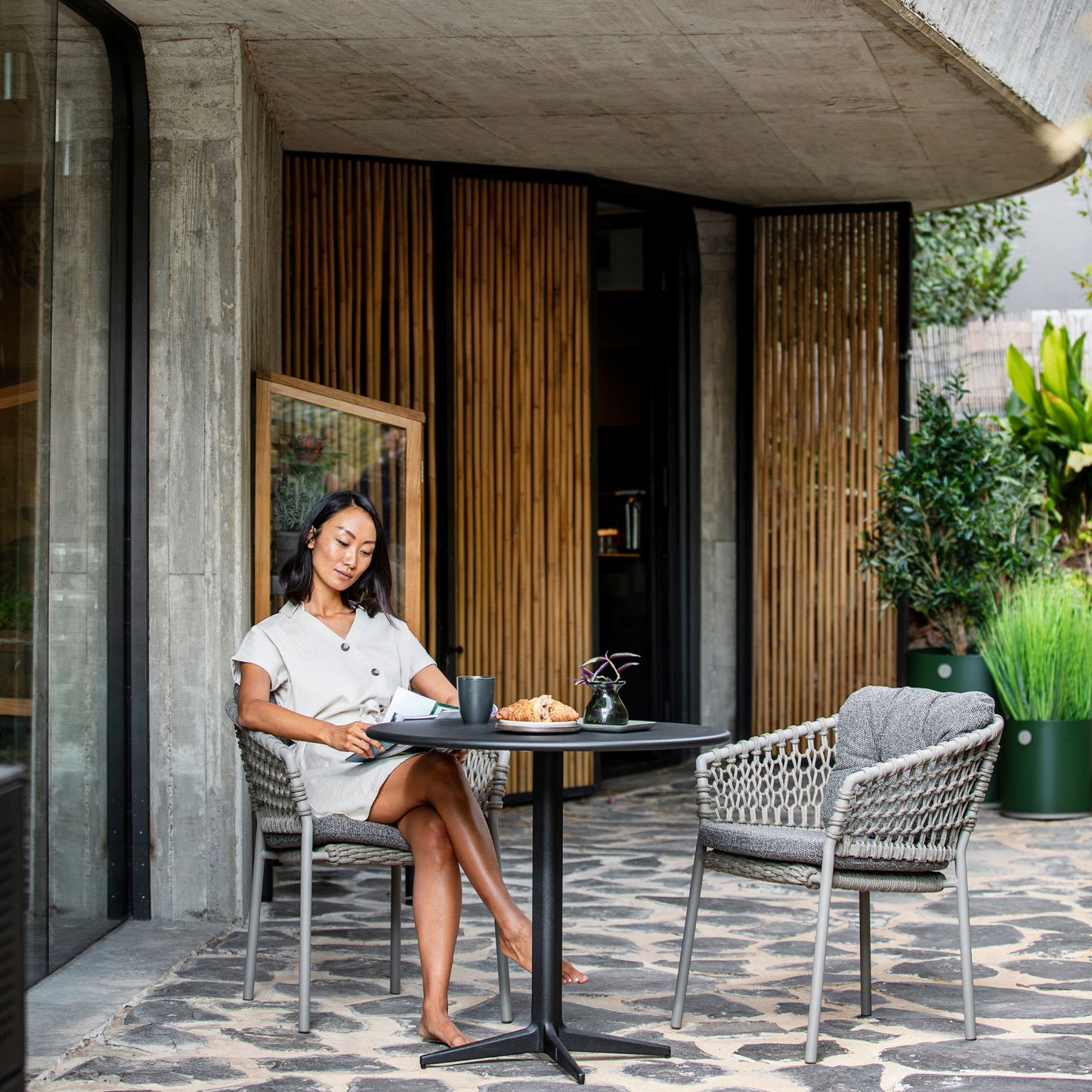 5417ROT_3 outdoor dining set with woman relaxing