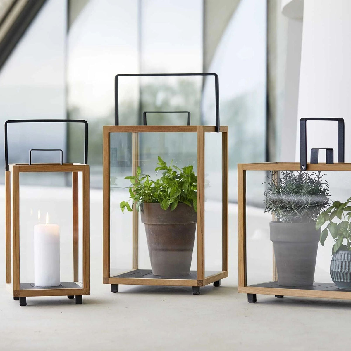 Wooden lanterns with plants and candle