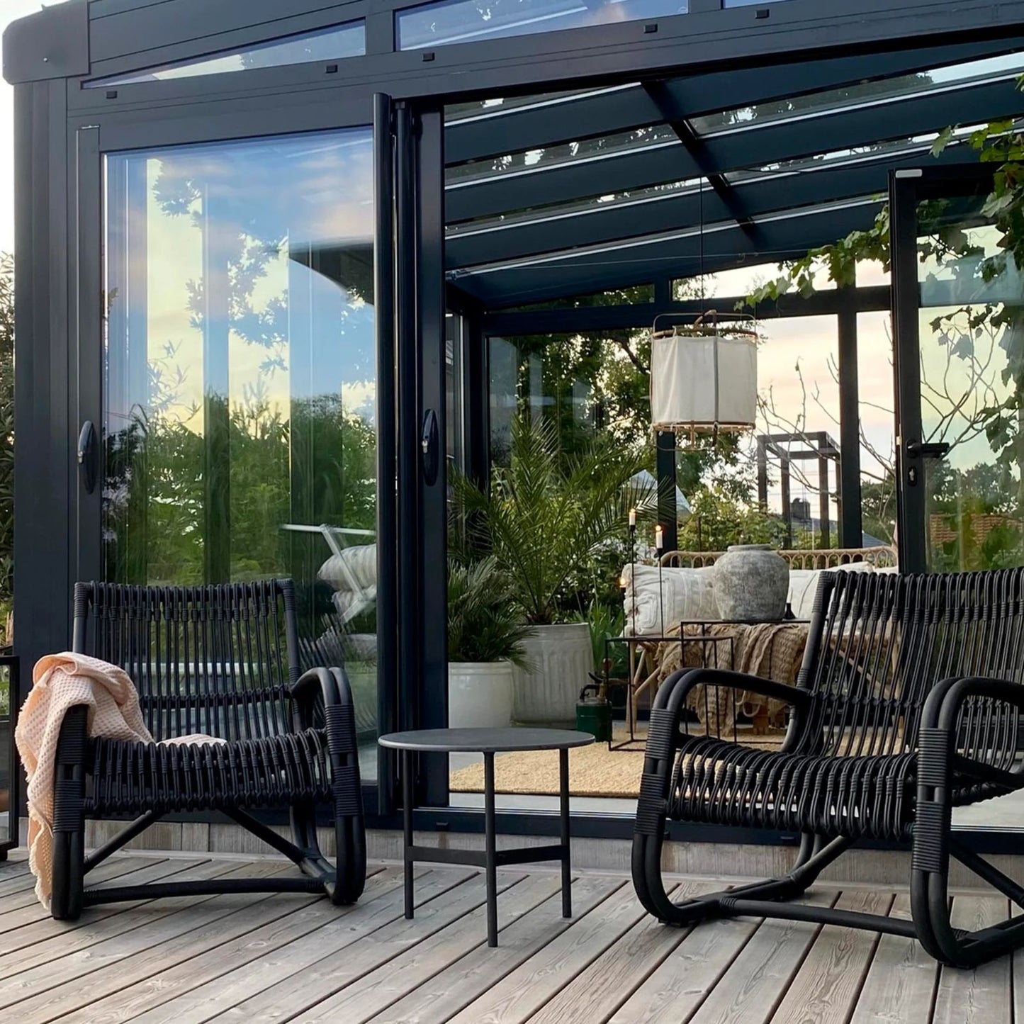Outdoor seating area with modern black chairs.