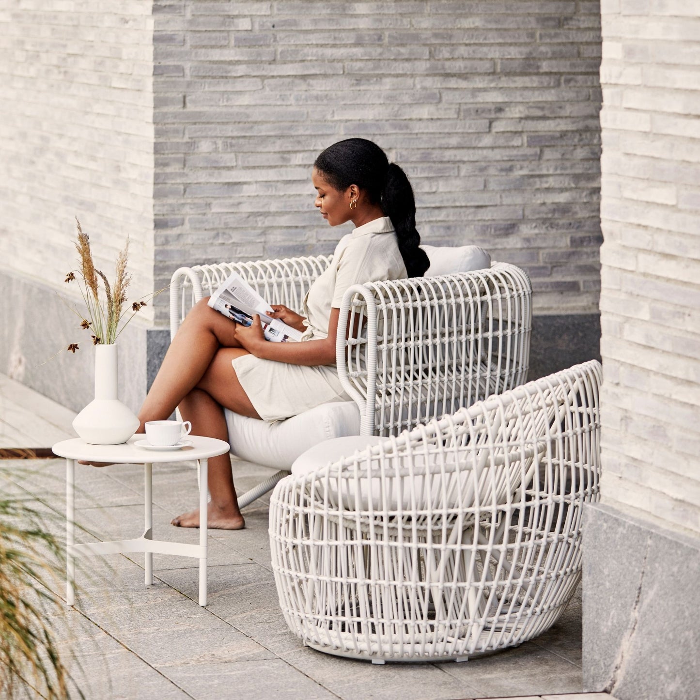 Woman relaxing on patio furniture, 57421WSW_2