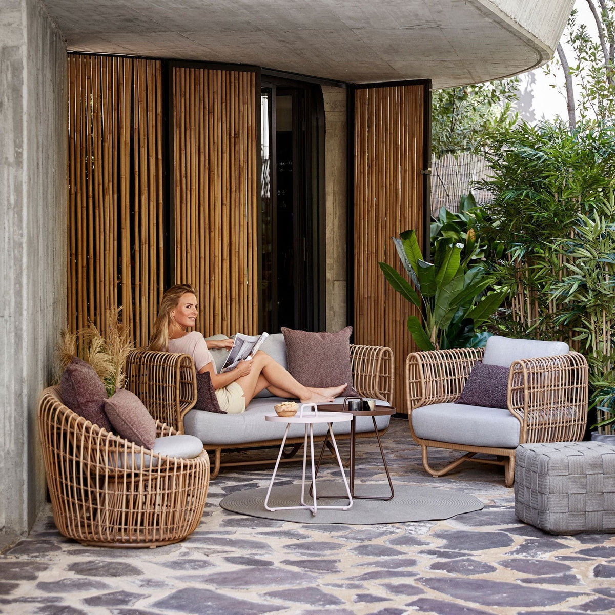 Outdoor wicker furniture set with woman reading