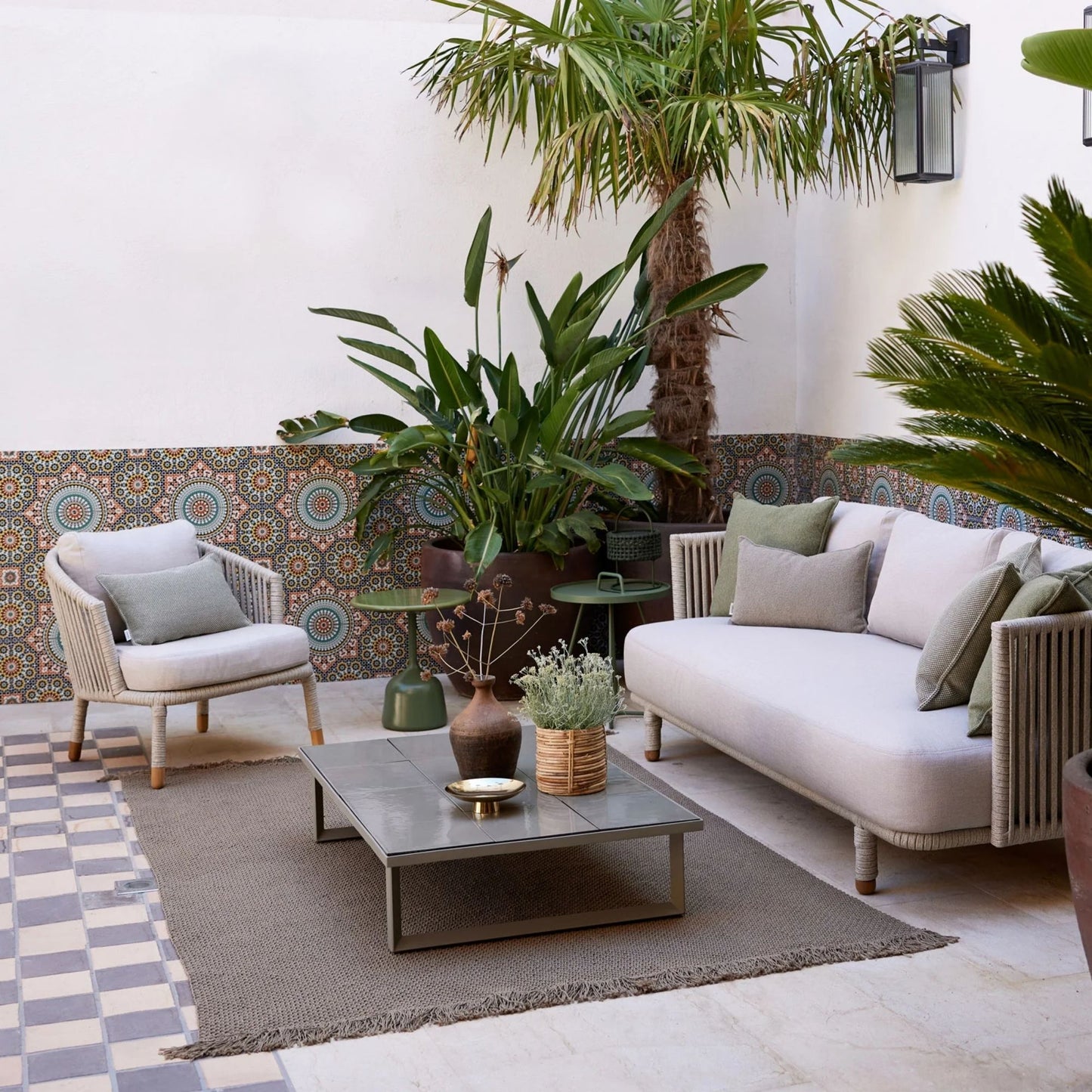 Outdoor seating area with sofa, chair, and table