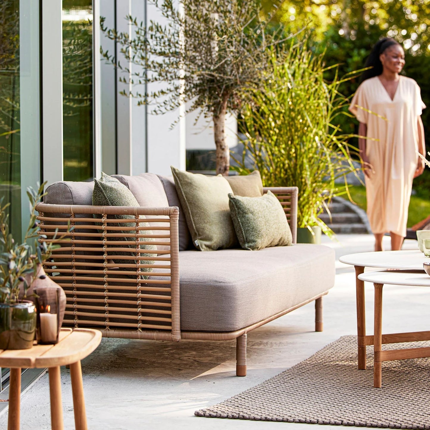 Outdoor sofa with woman in beige dress