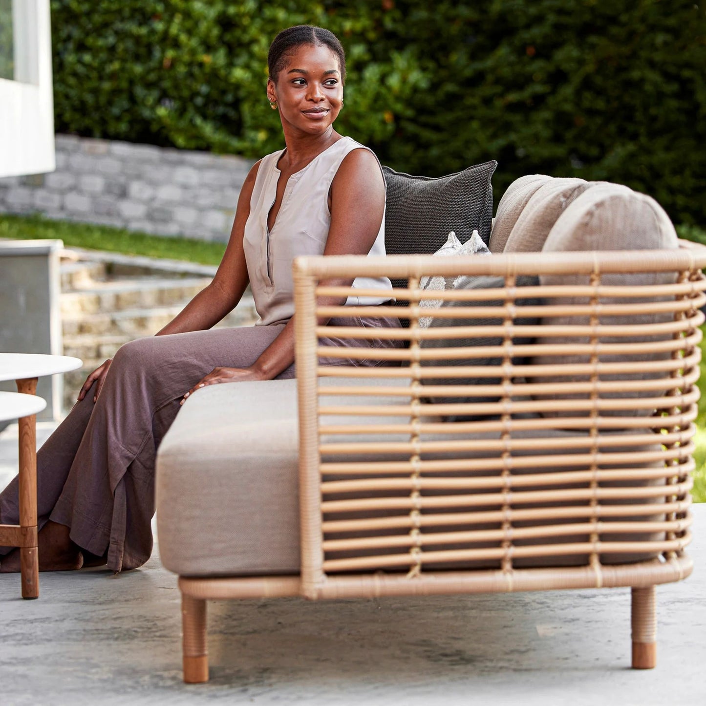 Woman on 7543UAITT_6 rattan sofa