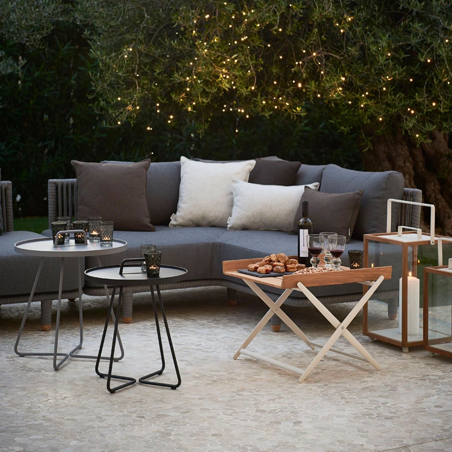 Outdoor seating with 7545ROGAITG_2, table and lights.