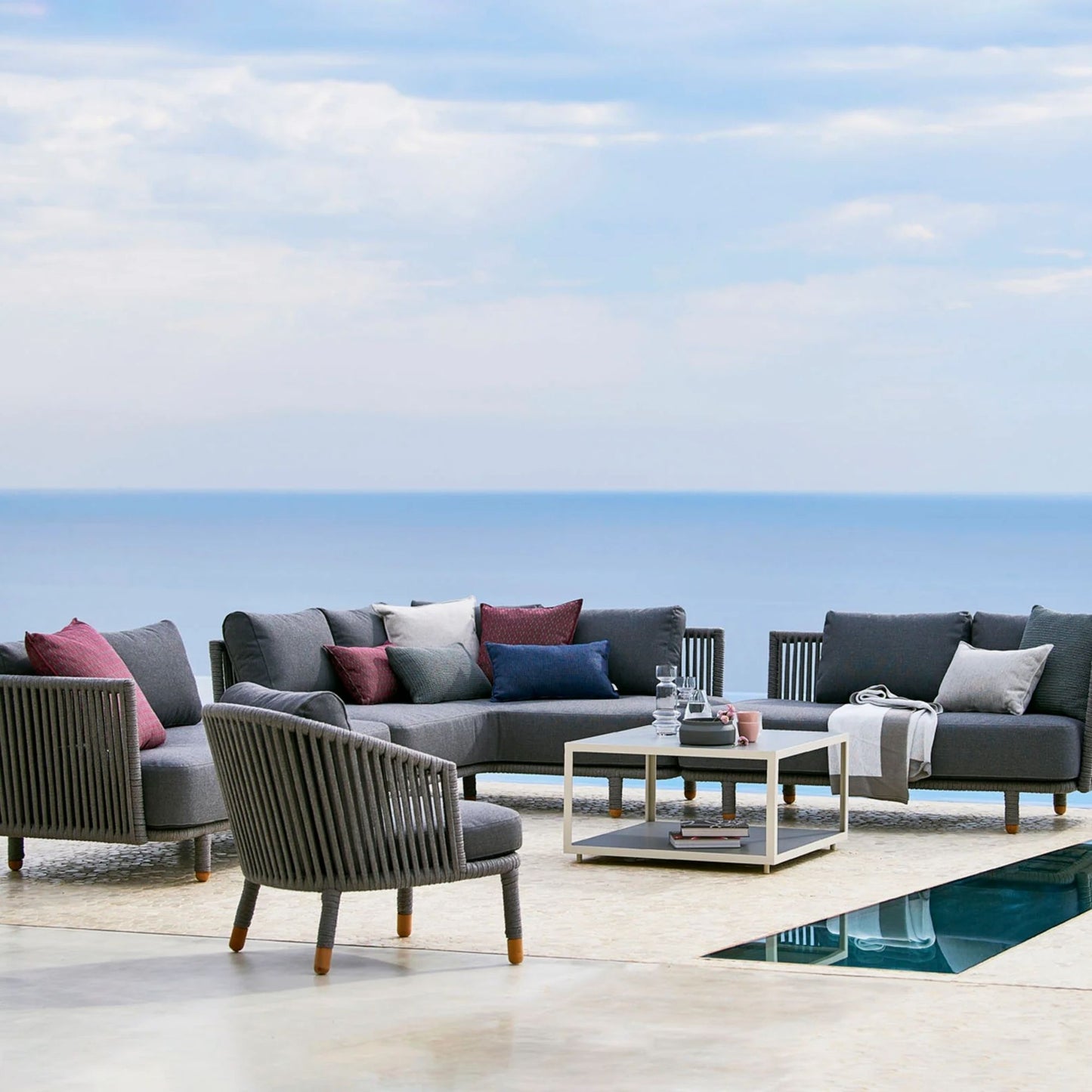 7545ROGAITG_4 outdoor sectional with pillows and coffee table