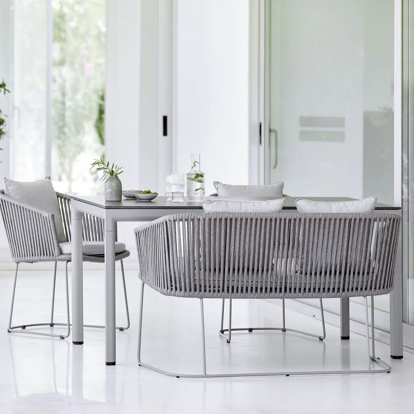 Outdoor dining set with grey rope chairs