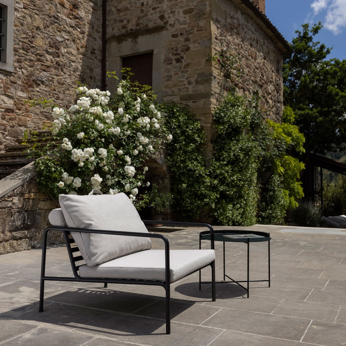 AVON CHAIR BLACK ASH on patio with side table