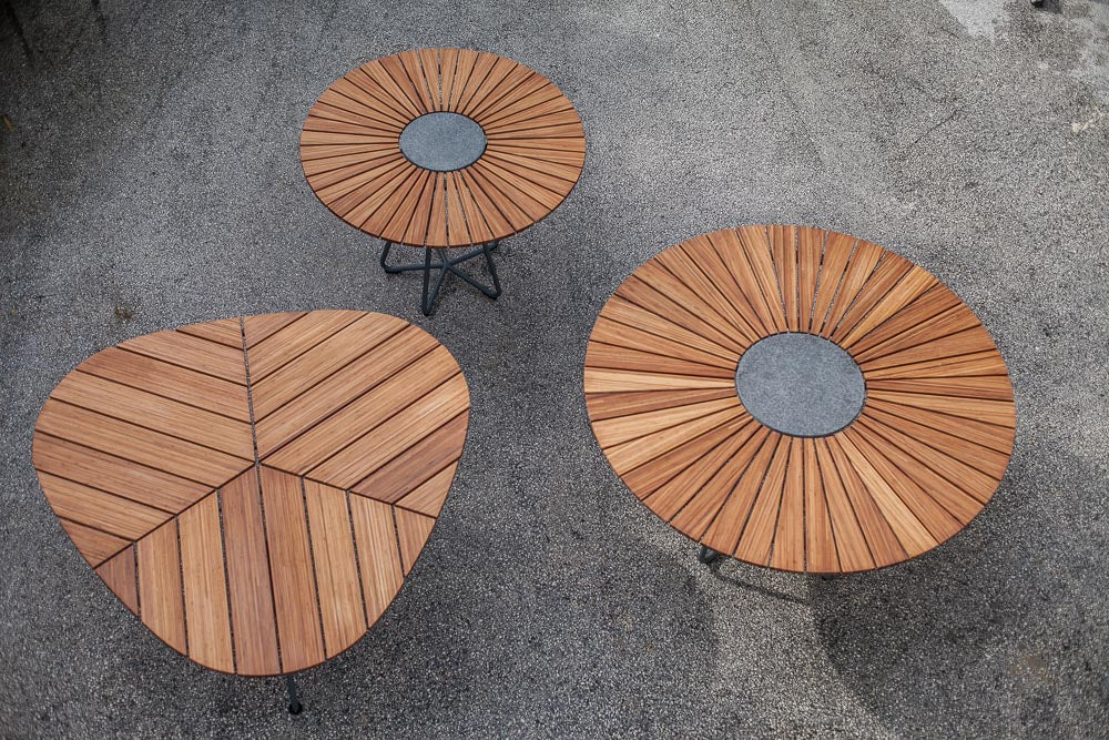 Three wood leaf-style patio tables