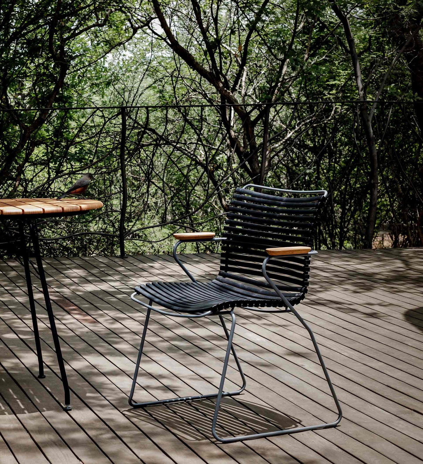 Black bamboo dining chair close up on deck