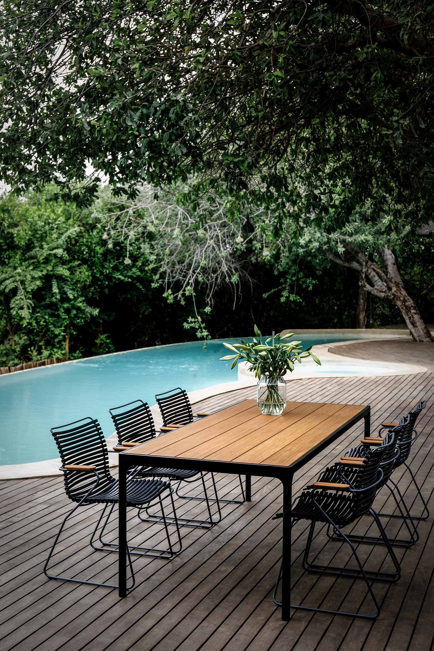 CLICK Dining black bamboo table & chairs near pool