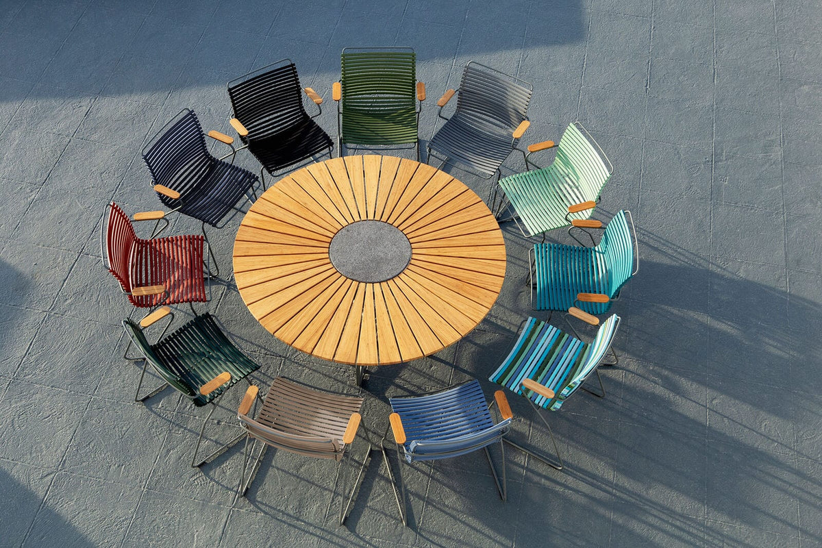 Dining table and colorful chairs arranged in a circle.