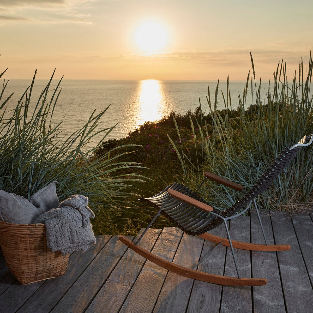 Black HOUE rocking chair on deck overlooking sunset
