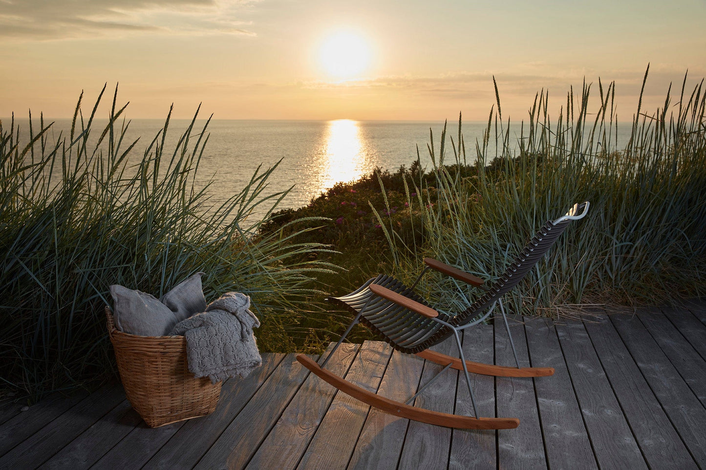 Black HOUE rocking chair on deck overlooking sunset