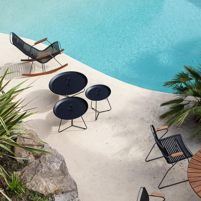 Black eyelet patio furniture by pool