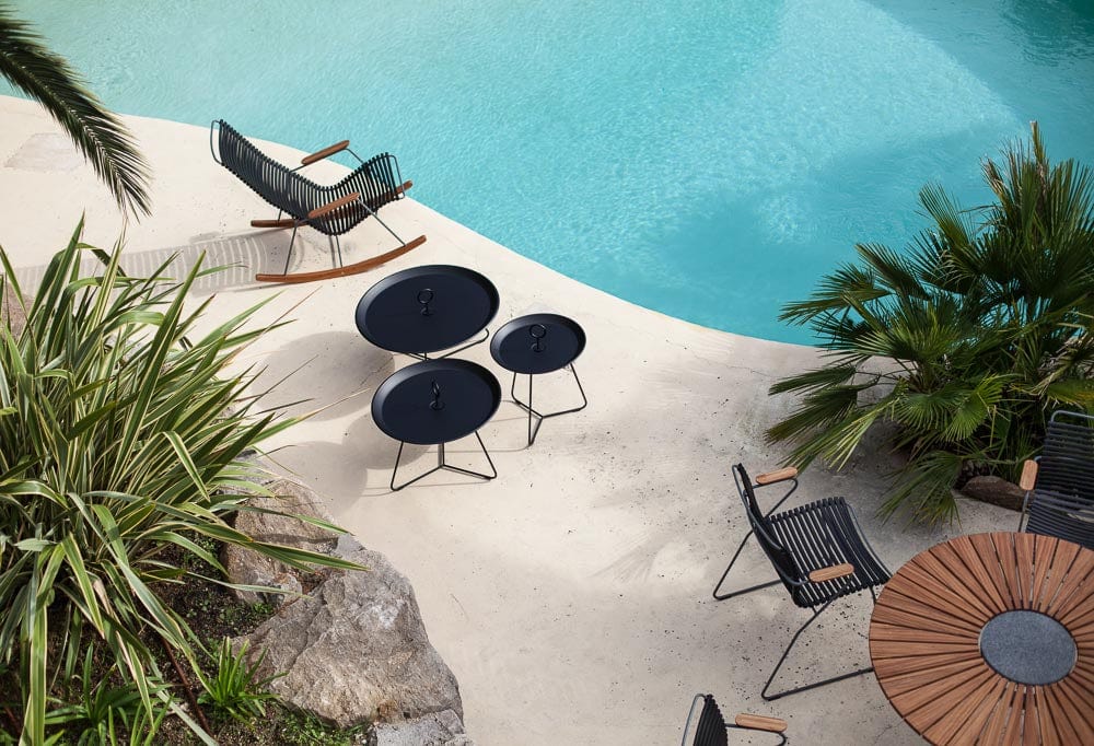 Black eyelet patio furniture set by pool