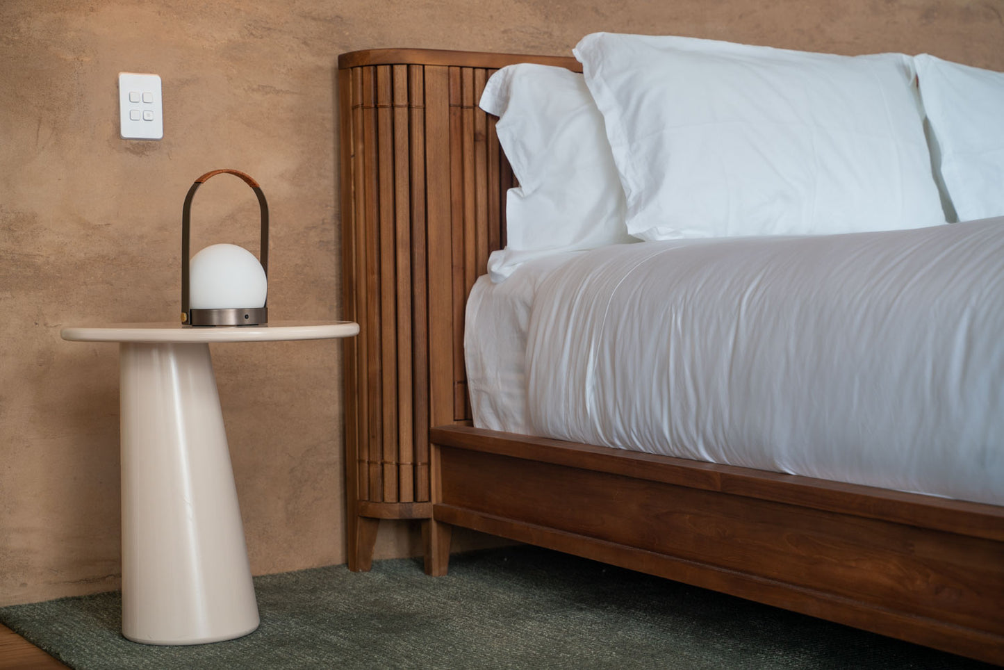 Bedroom with bed, lamp, and wooden headboard