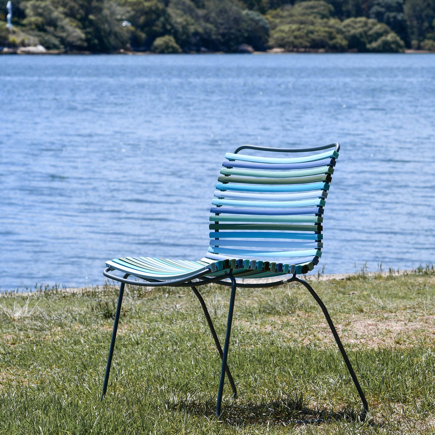 Blue striped outdoor chair by water