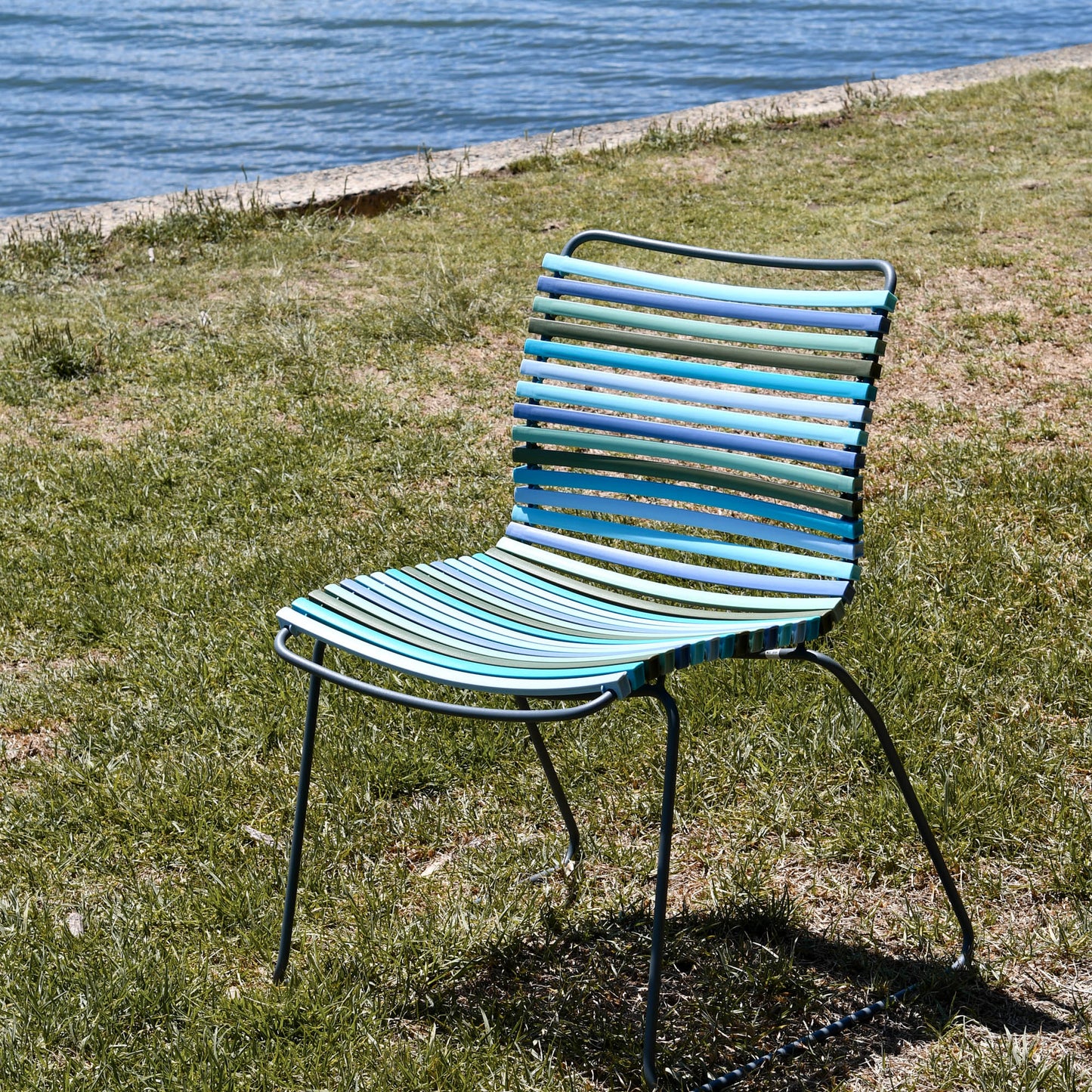 Blue striped chair by water