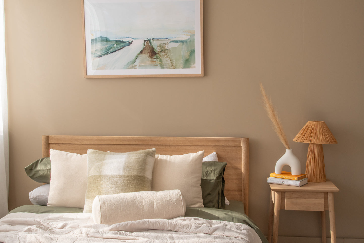 Bedroom decor with artwork, bed, and side table (DSC_1729)