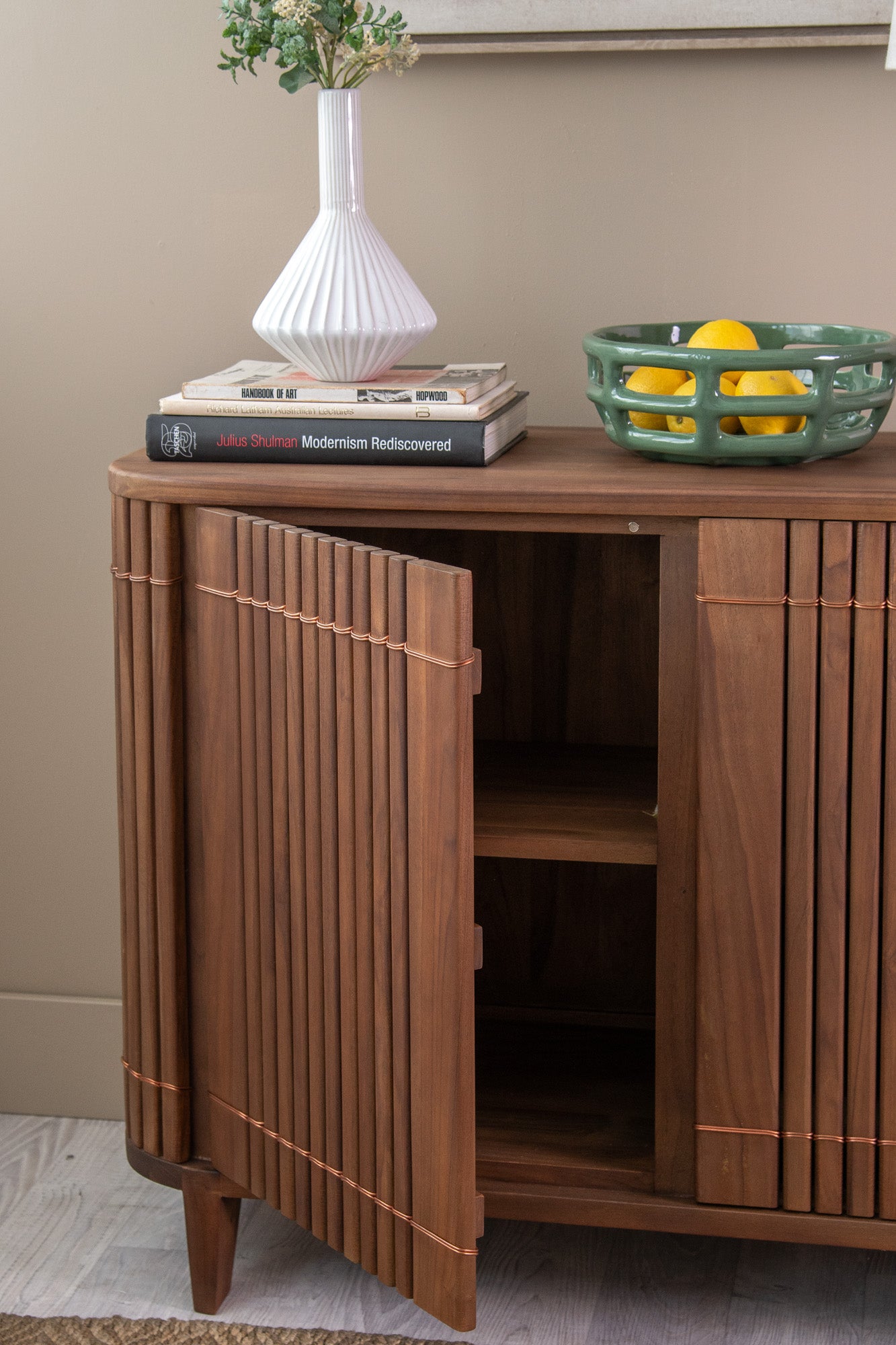 Wooden cabinet with decor and lemons.
