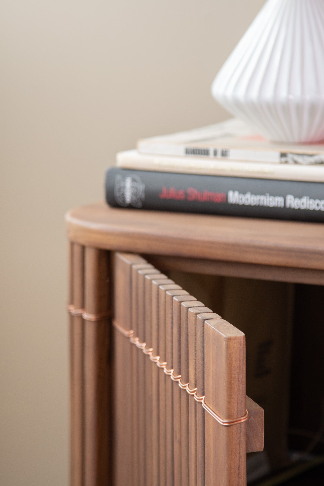 Wooden cabinet with books and vase