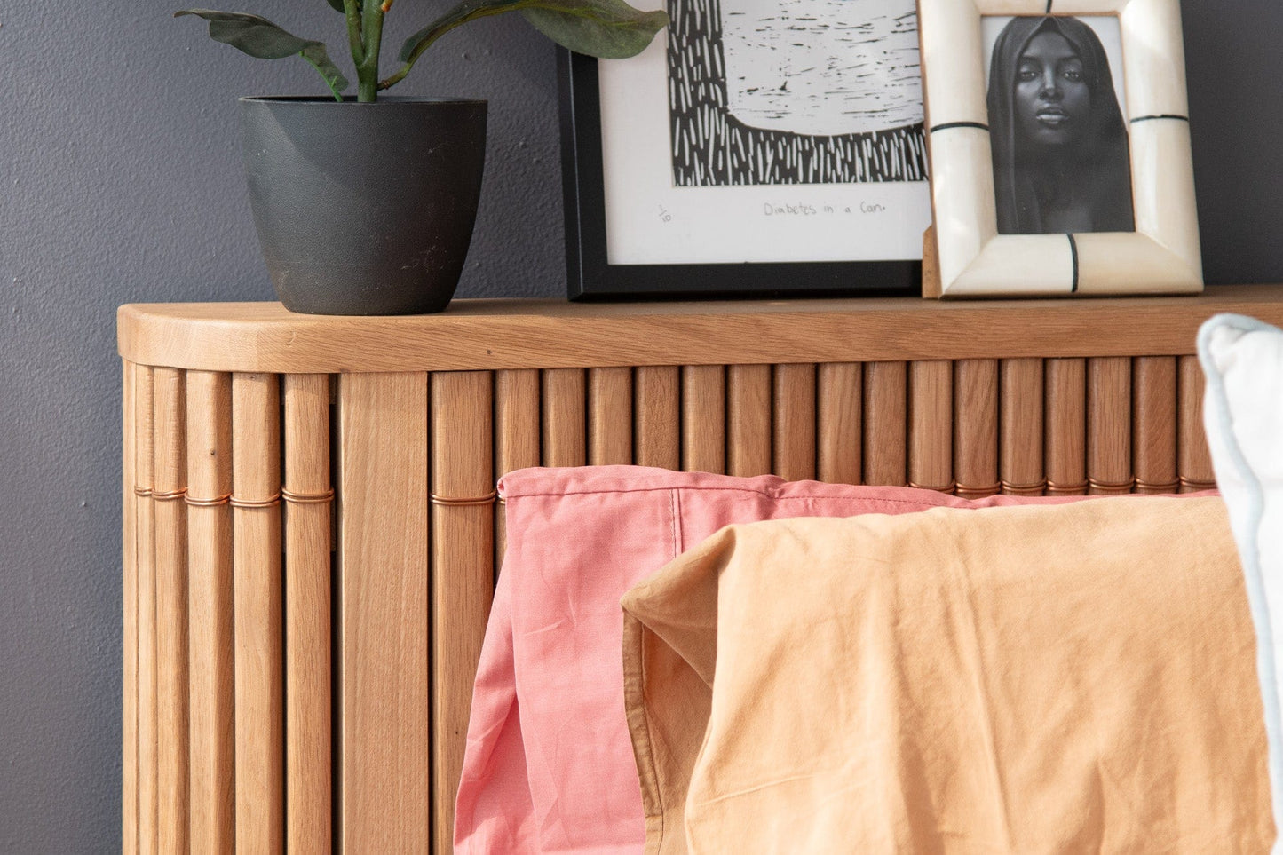 Wooden bed frame with art and shirts - DSC_2254