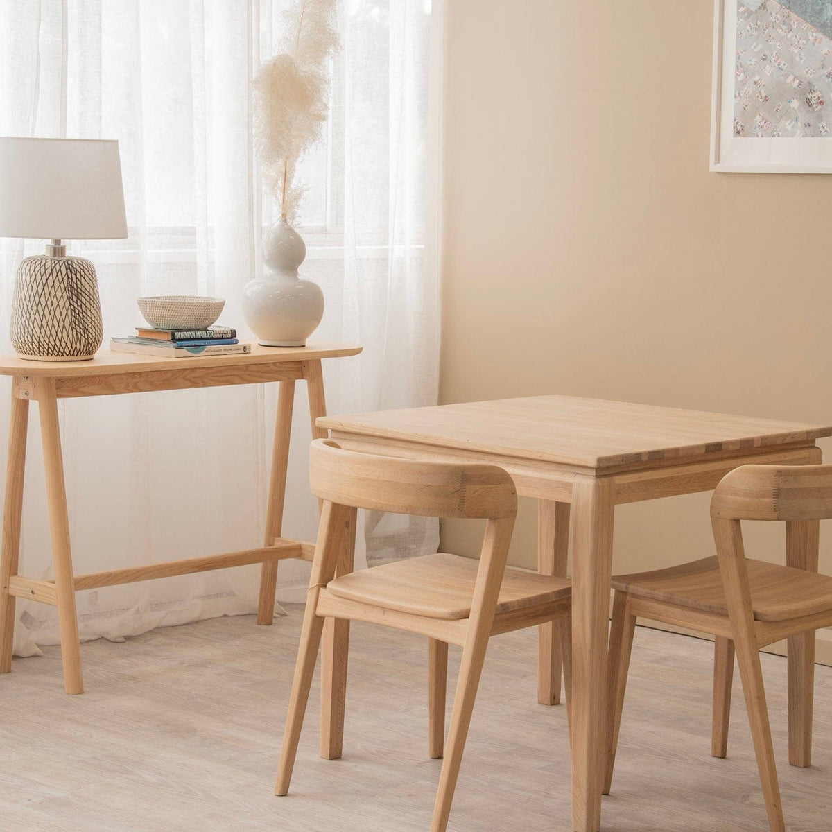 Light wood table and chairs in a bright room.