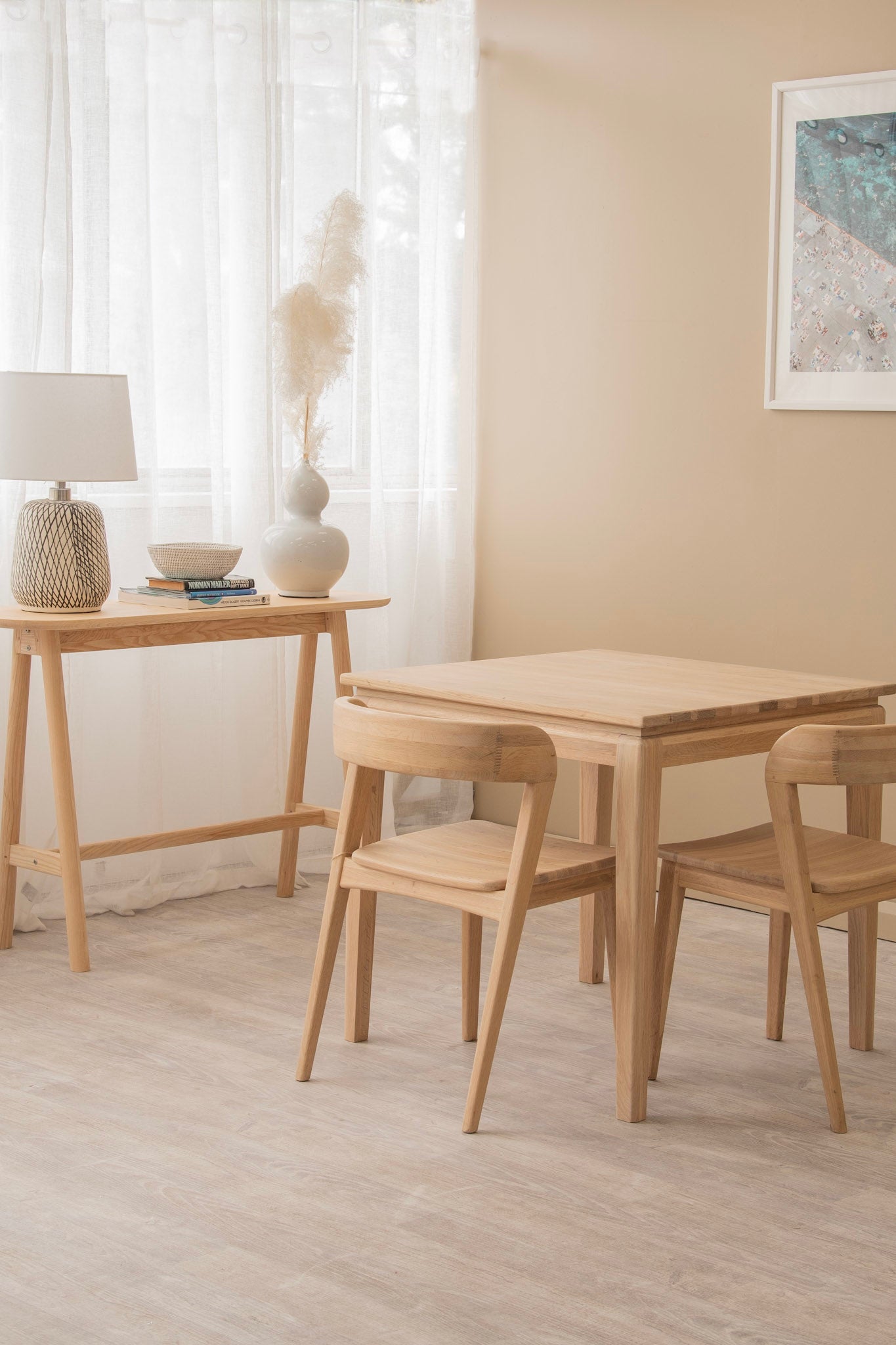 Light wood table and chairs in a bright room.