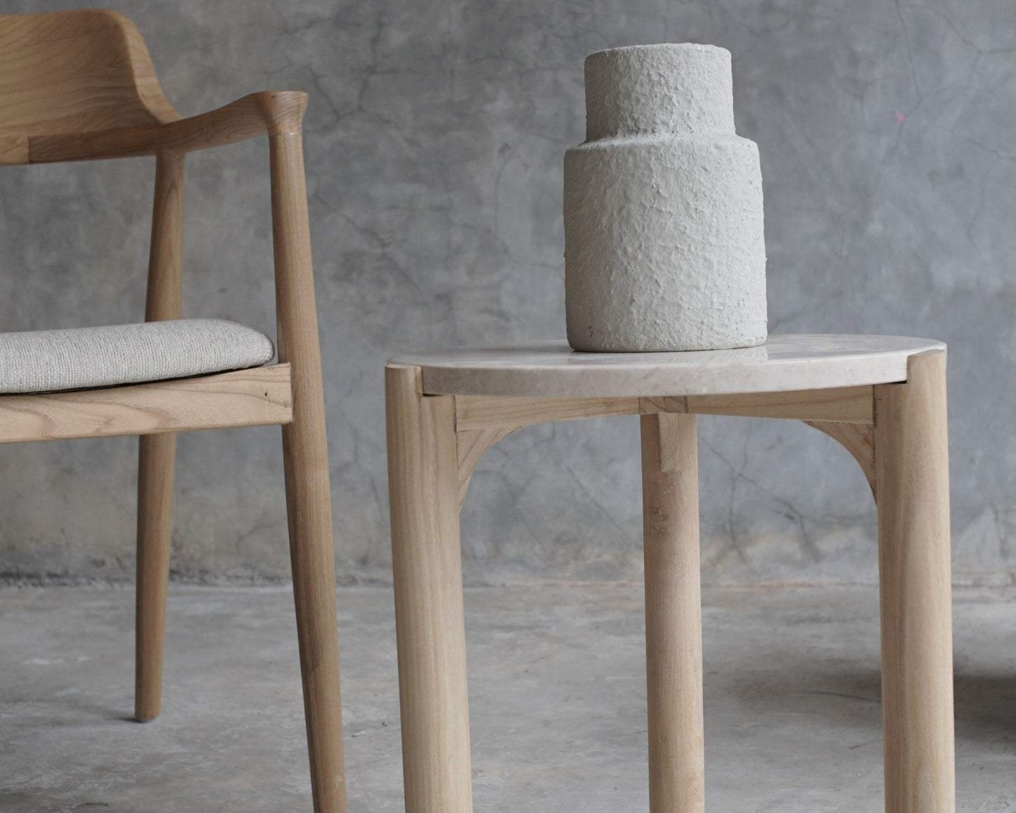 Wooden chair, side table, and textured vase