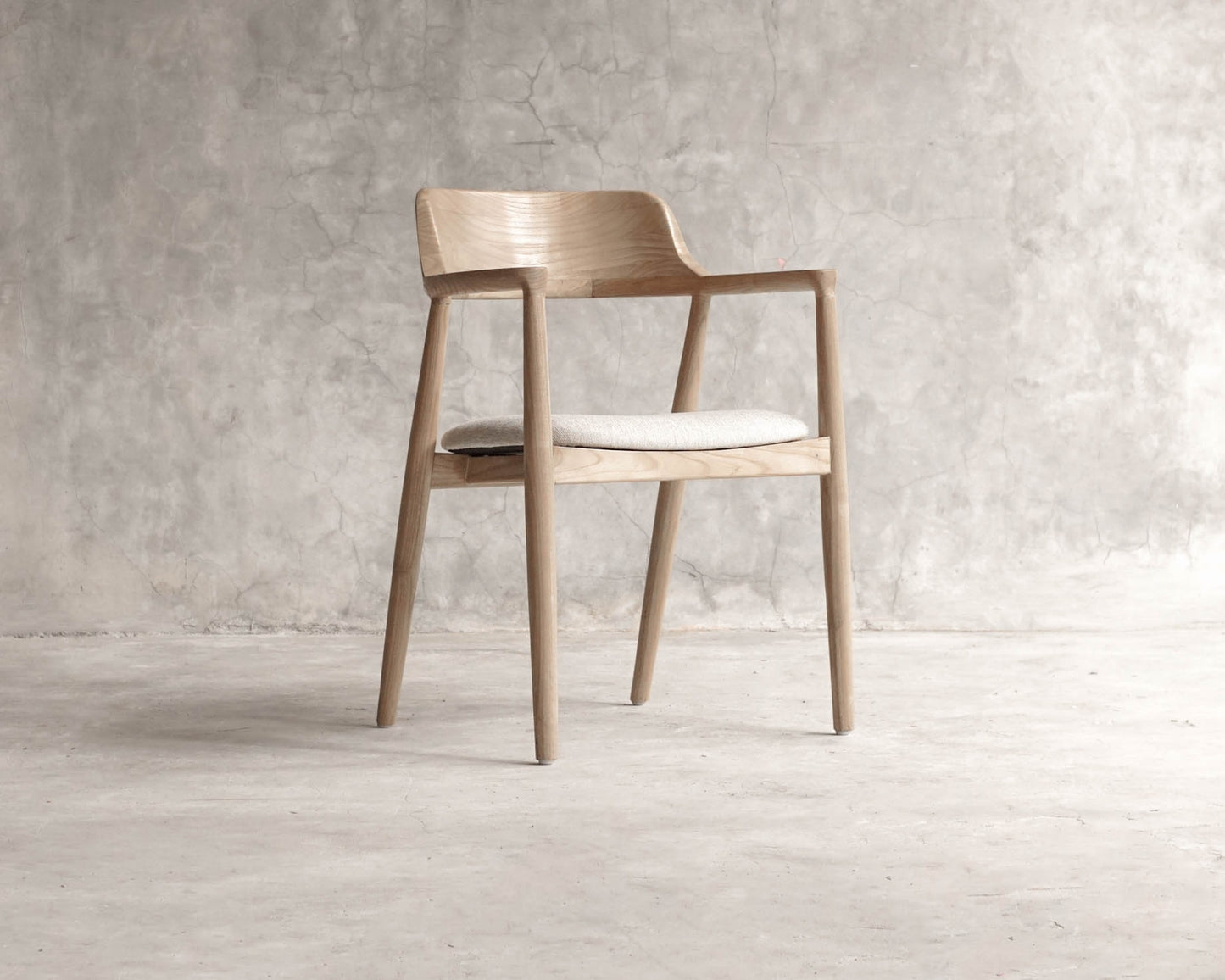 Wooden armchair with white cushion
